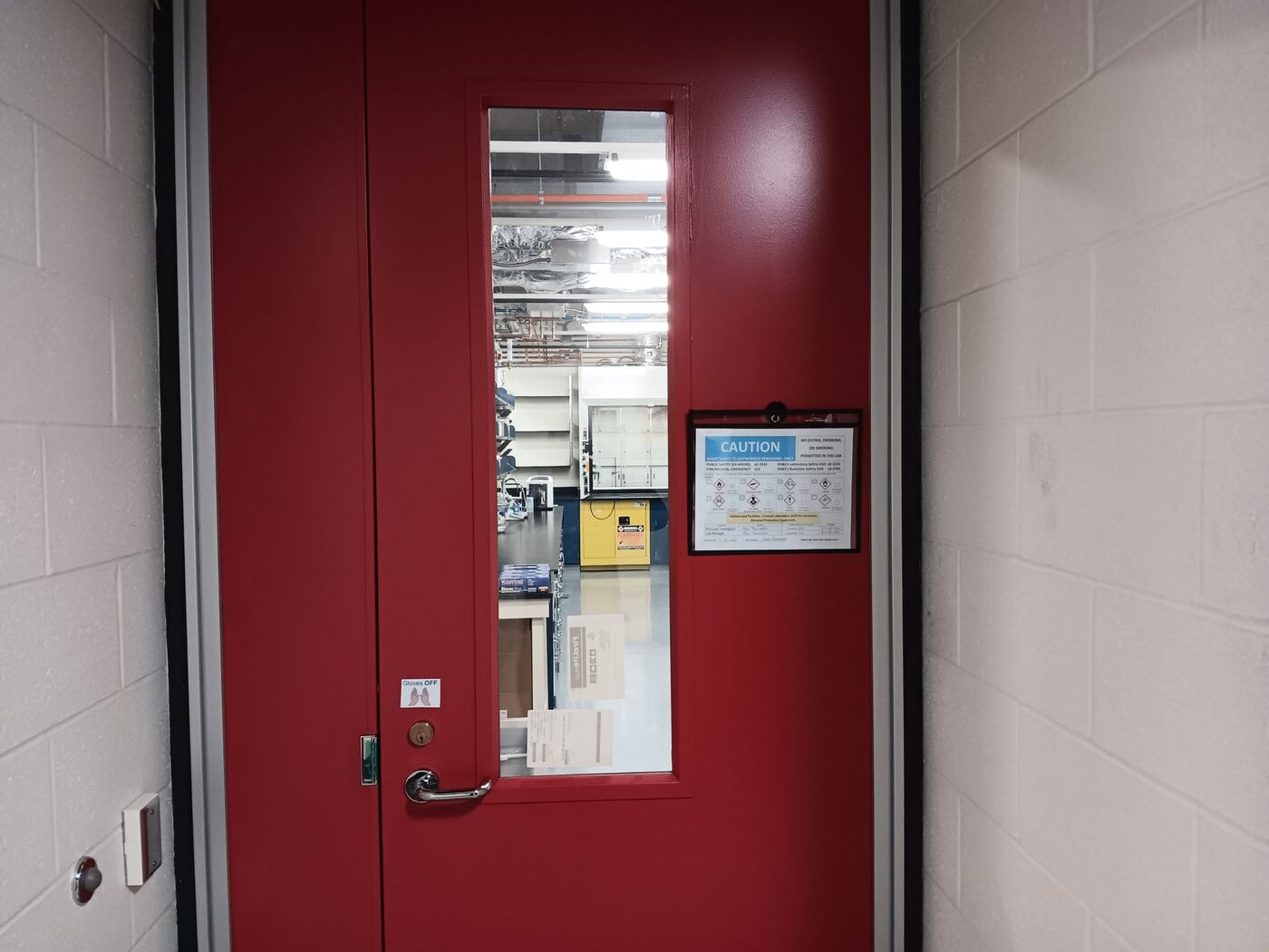 Locked laboratory access door with an authorized-personnel-only caution sign at a biotech research facility