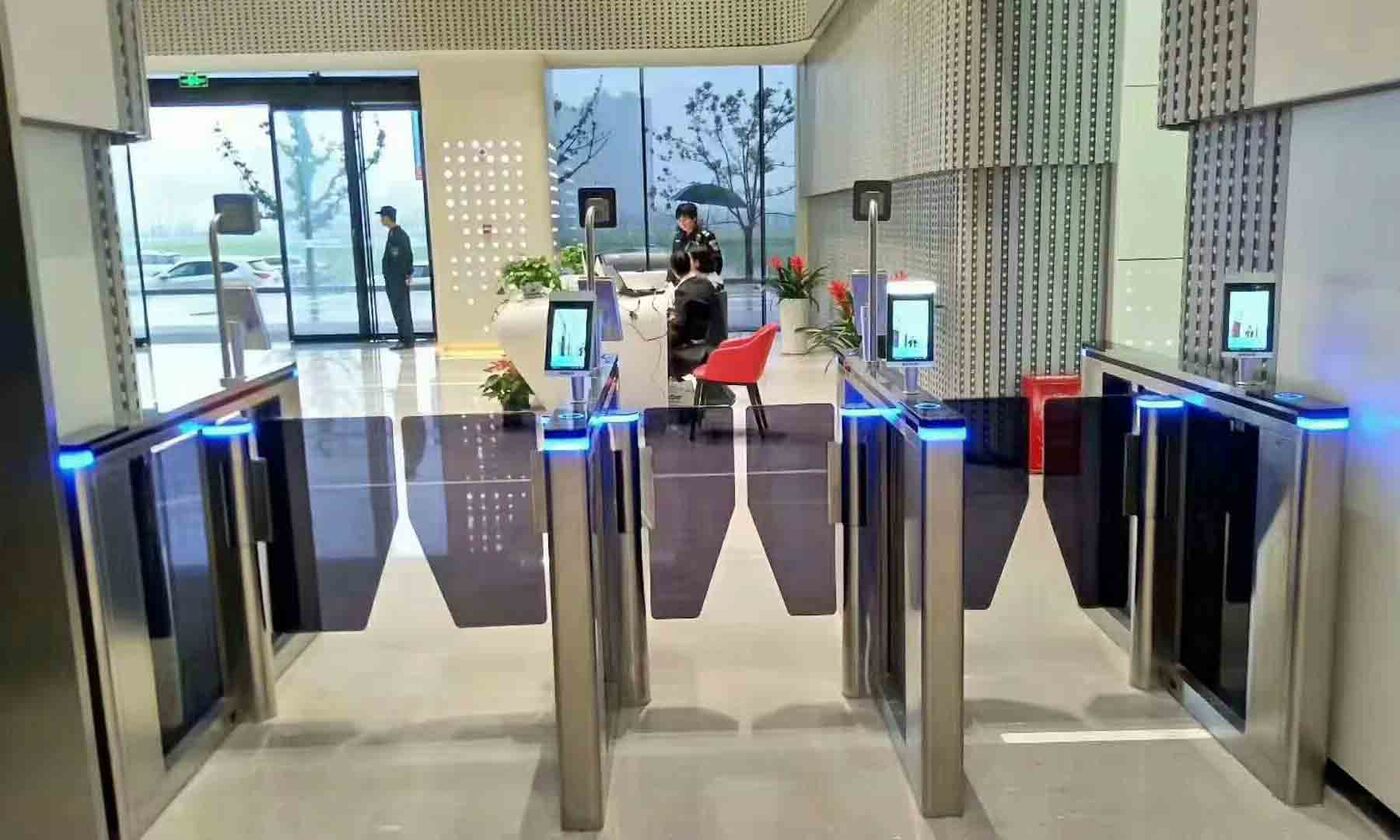 Lobby speed-gate turnstiles with badge readers, the kind of access control point tested during an insider threat assessment
