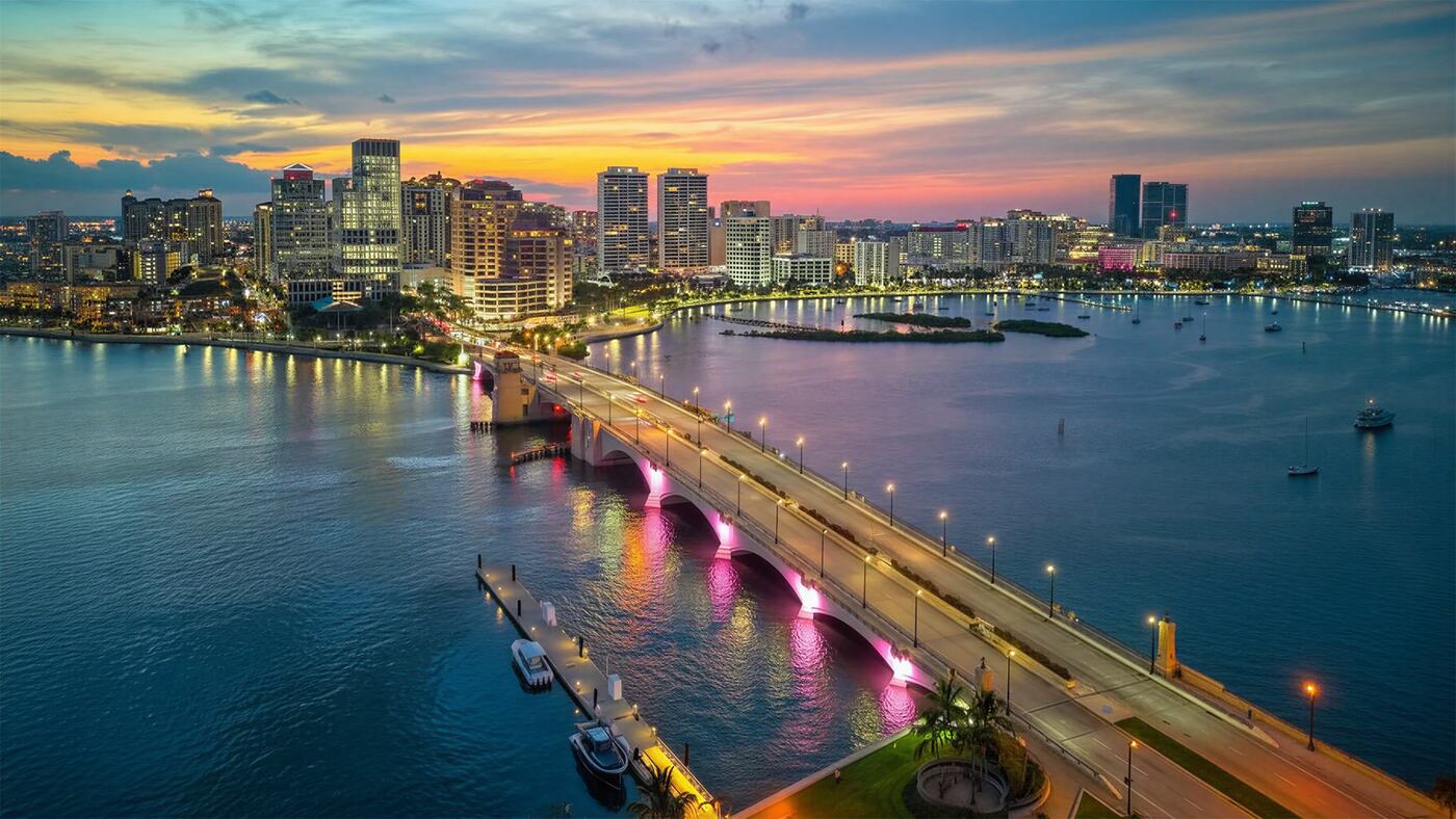 Downtown West Palm Beach skyline at dusk, where the county's financial, medical, and professional firms concentrate